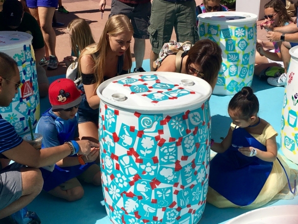 Families paint rain barrels at the 25th Annual EPCOT Flower and Garden Festival