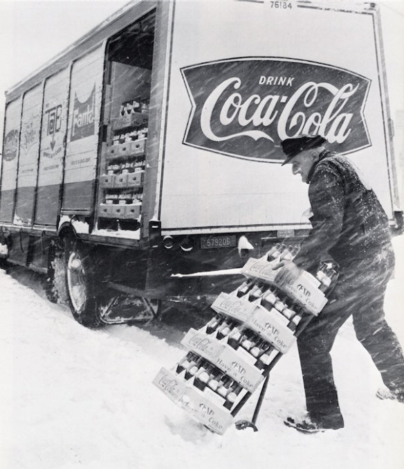 A snowy picture of a truck loaded with products