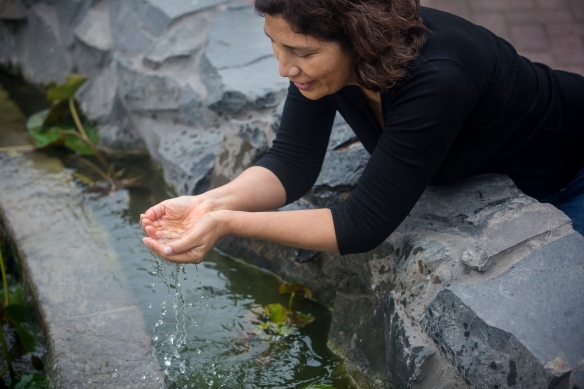 Woman enjoying clean water from natural water resource
