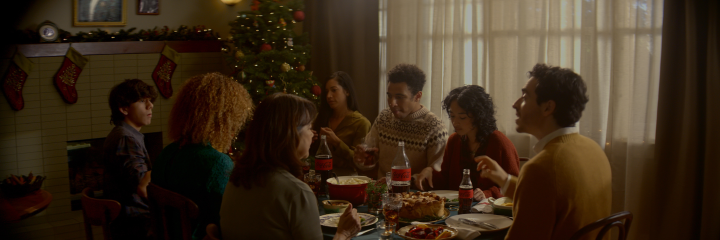 people sit around a dinner table eating and talking