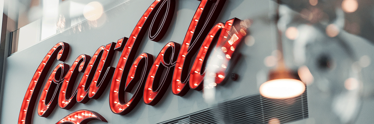 Large red marquee sign of Coca-Cola script logo A Coca-Cola marquee sign