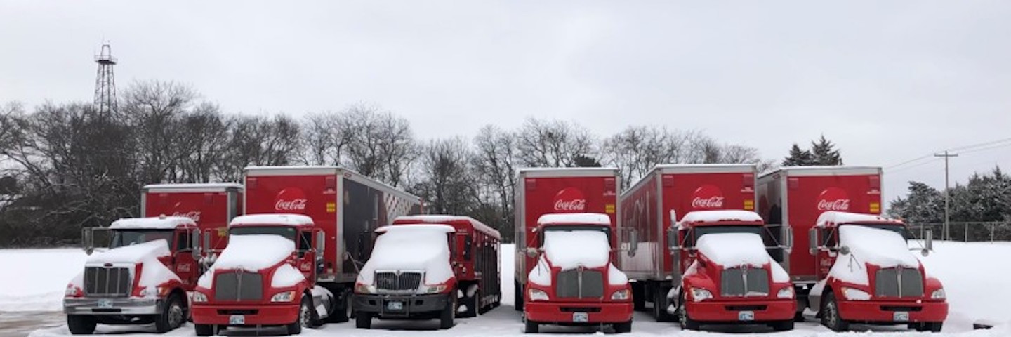 Coca-Cola delivery trucks covered in snow