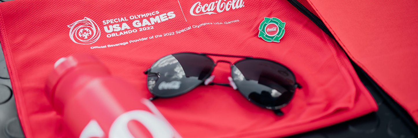 Coca-cola special olymics sponsorship bag with sunglasses and water bottle