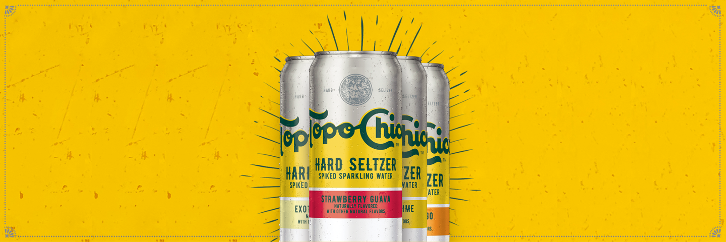 Four cans of Topo Chico Hard Seltzer variants