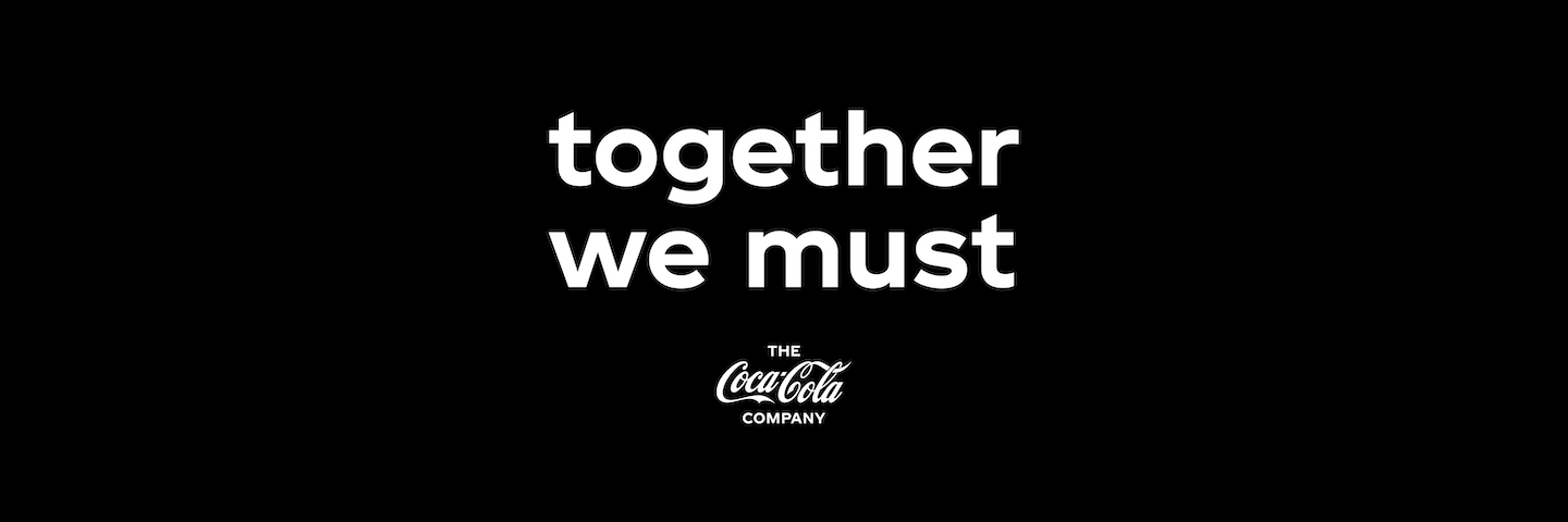 White together we must logo on a black background Together We Must