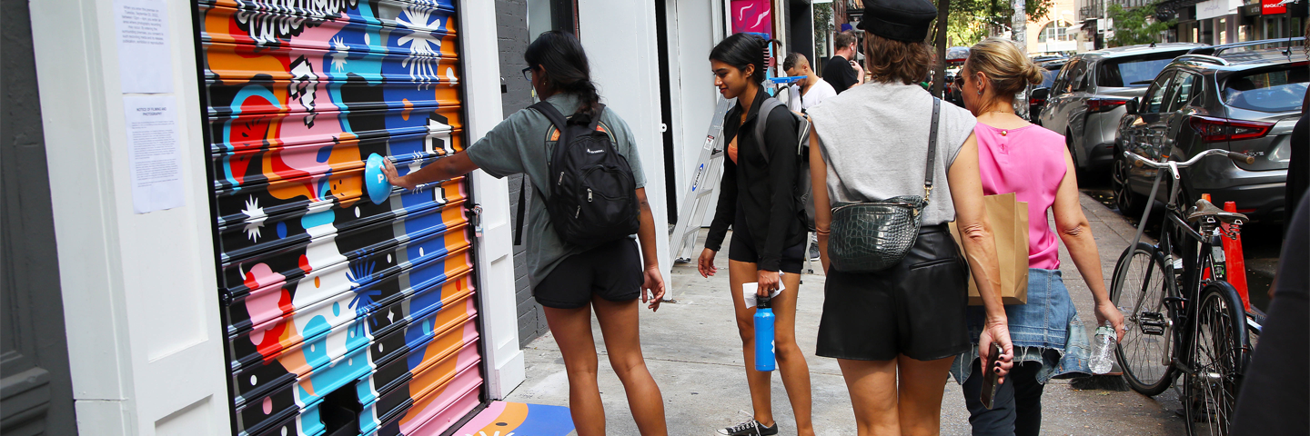 people in front of an nyc mural featuring wtfanta