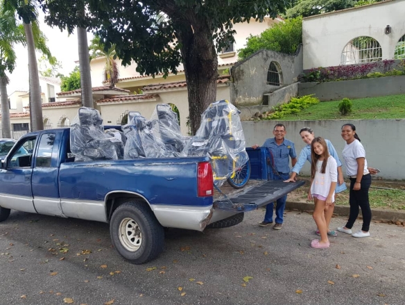 A WOH volunteer loads wheelchairs to be delivered to kids with cerebral palsy in Guarana, Venezuela.