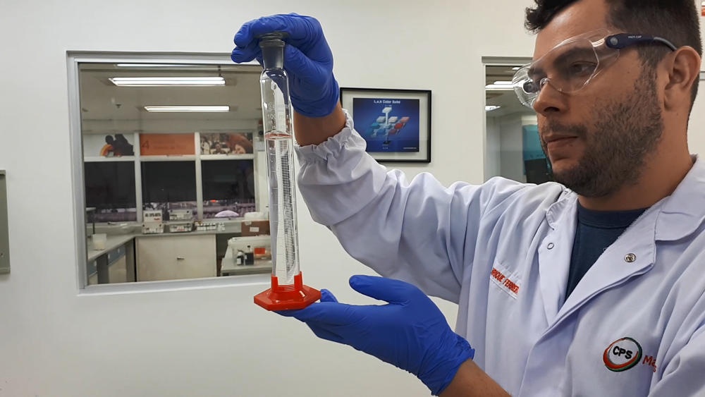 An associate at the Coca-Cola concentrate plant in Manaus, Brazil, produces hand sanitzer.