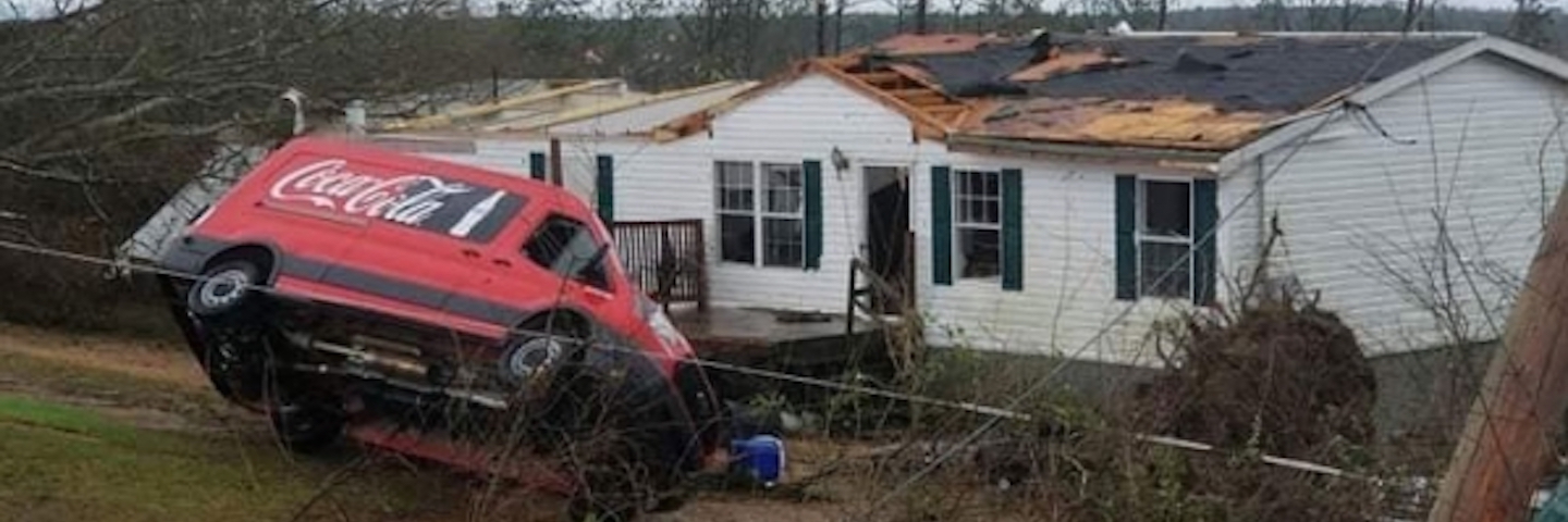 tornado hits a house and a Coca-Cola car