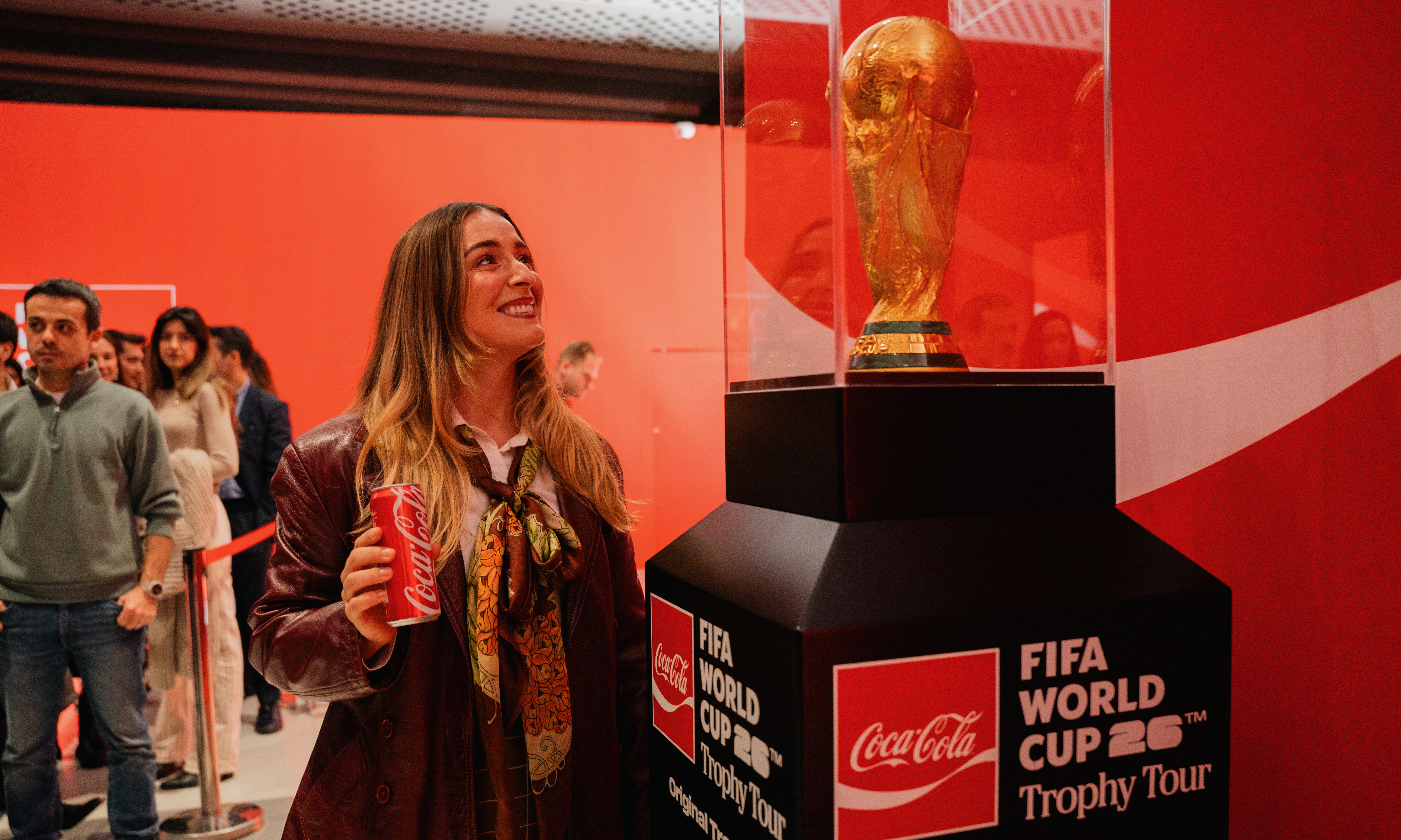 A fan gets and up close view of a FIFA World Cup Trophy