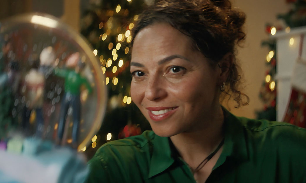 Woman looking at snow globe