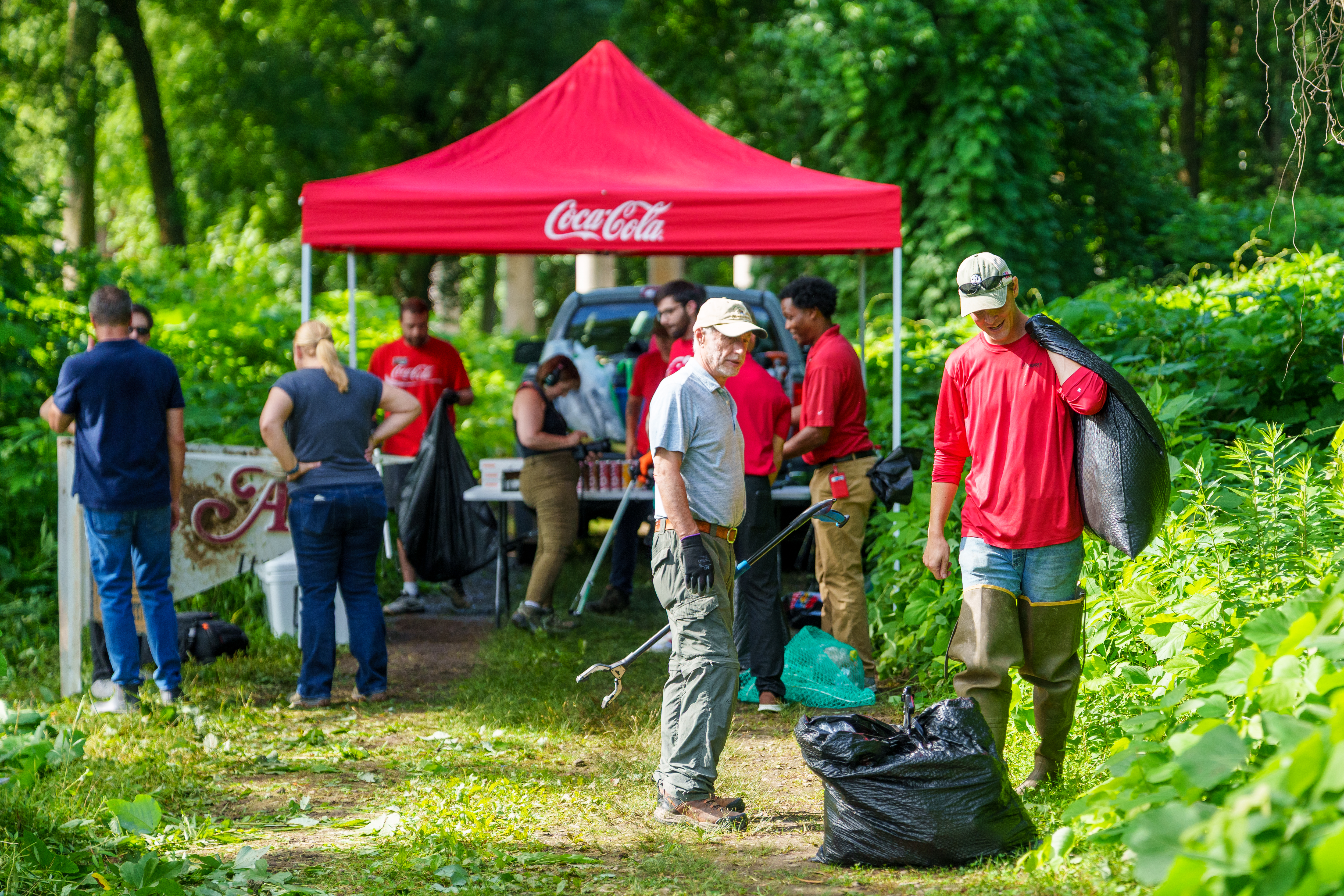 Volunteers from Coca-Cola, Osprey, and South Fork Conservancy clean up trash in South Fork