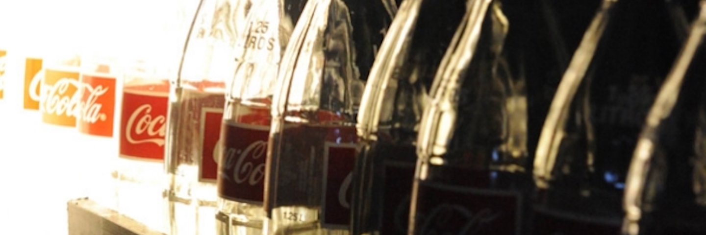 A lot of coca-cola bottles in the shining sun