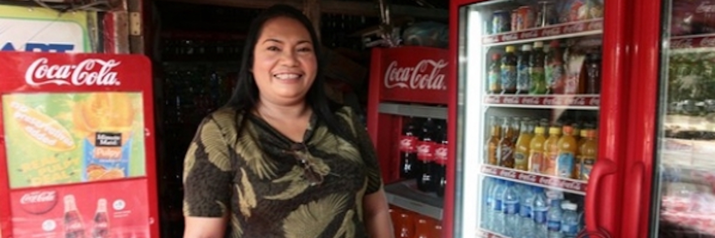 A happy woman surrounded by coca-cola products