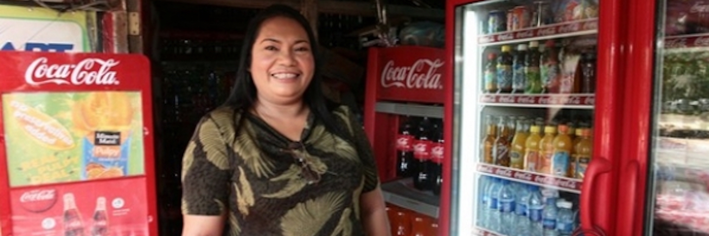 A happy woman surrounded by coca-cola products