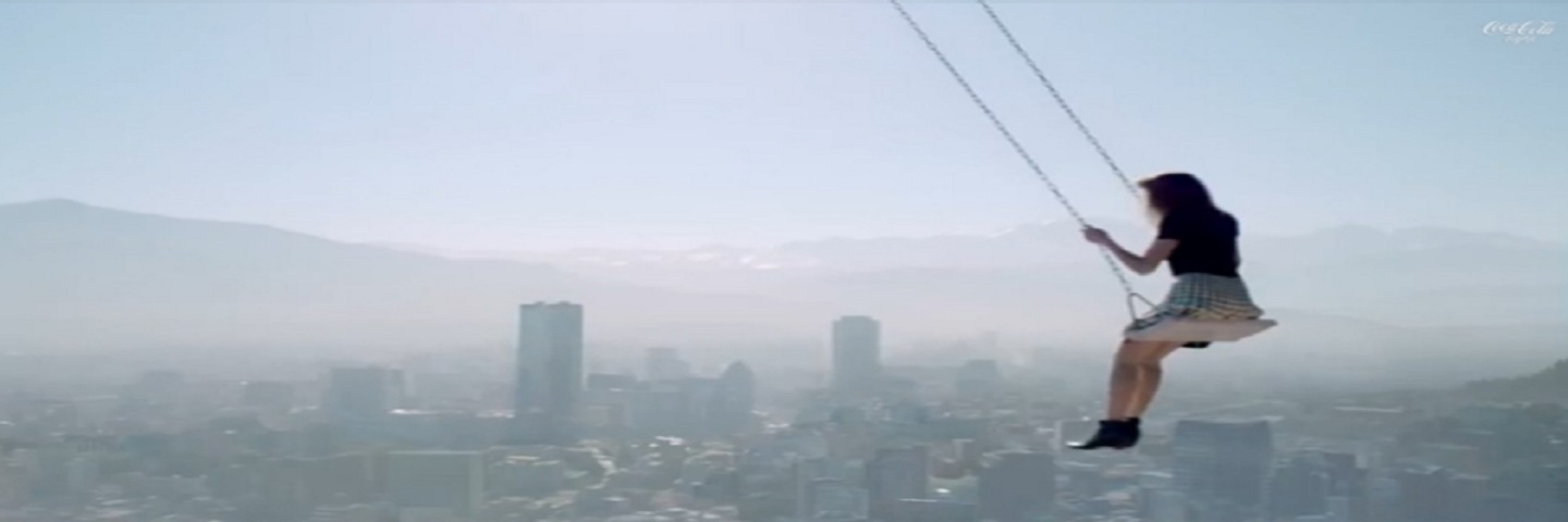 A girl on a swing above a city