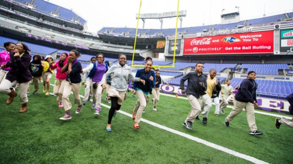 Kids running on a football field