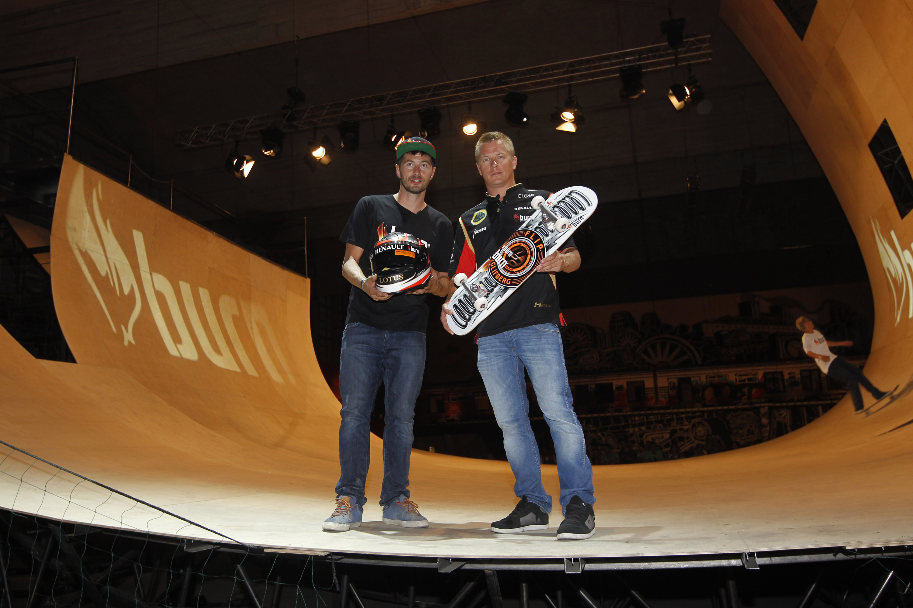  Lotus F1¨ Team driver Kimi R ikk nen exchanging his F1 helmet for a customised skateboard from champion skateboarder Rune Glifberg at burn Yard Live in Budapest, 26th July 2013