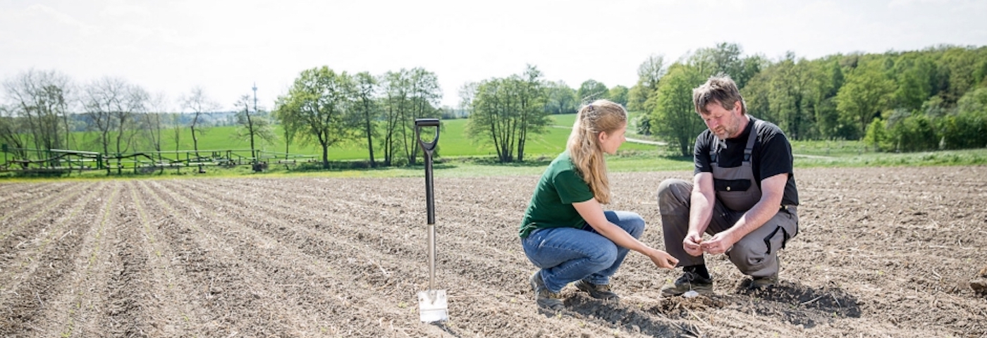 Man and woman inspect soil With global reach in more than 200 countries, we have an opportunity and responsibility to positively contribute to more sustainable agriculture practices worldwide.