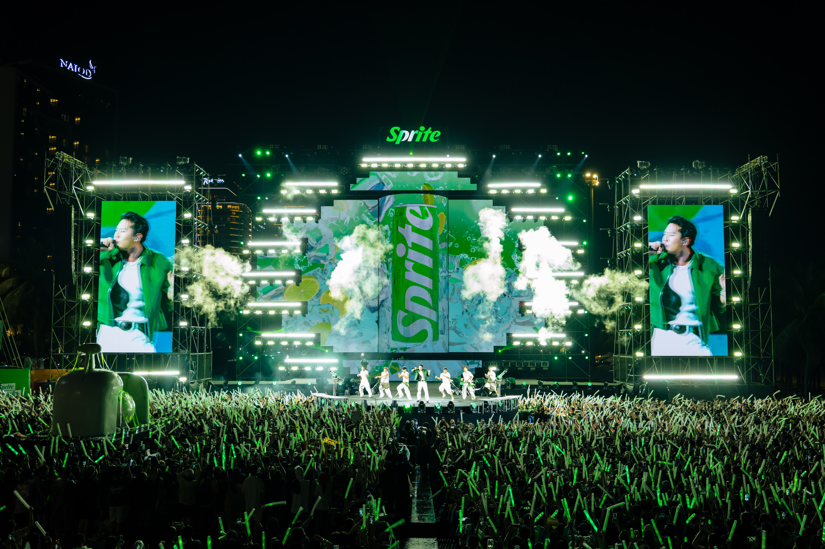 A group dancing and singing on stage