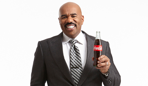 Steve Harvey holding a Coke Bottle