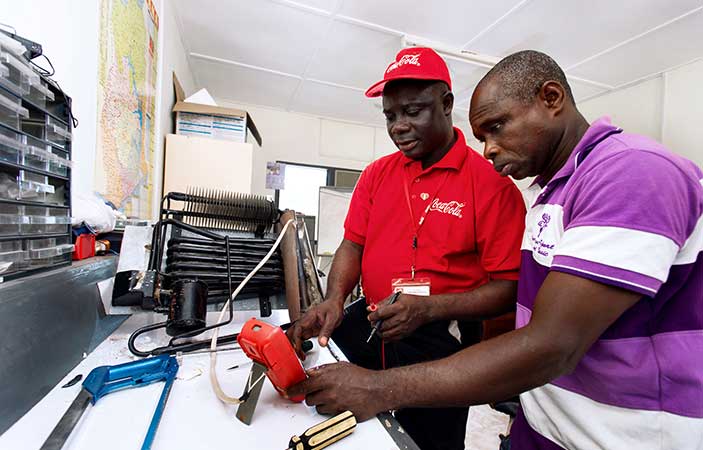 African men discuss medicine distribution