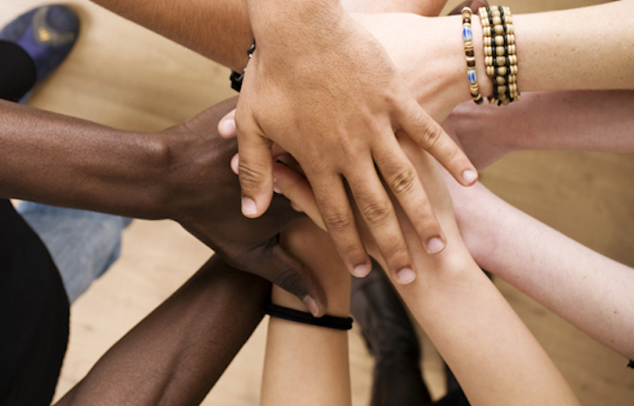 Diverse hands stacked on top of one another