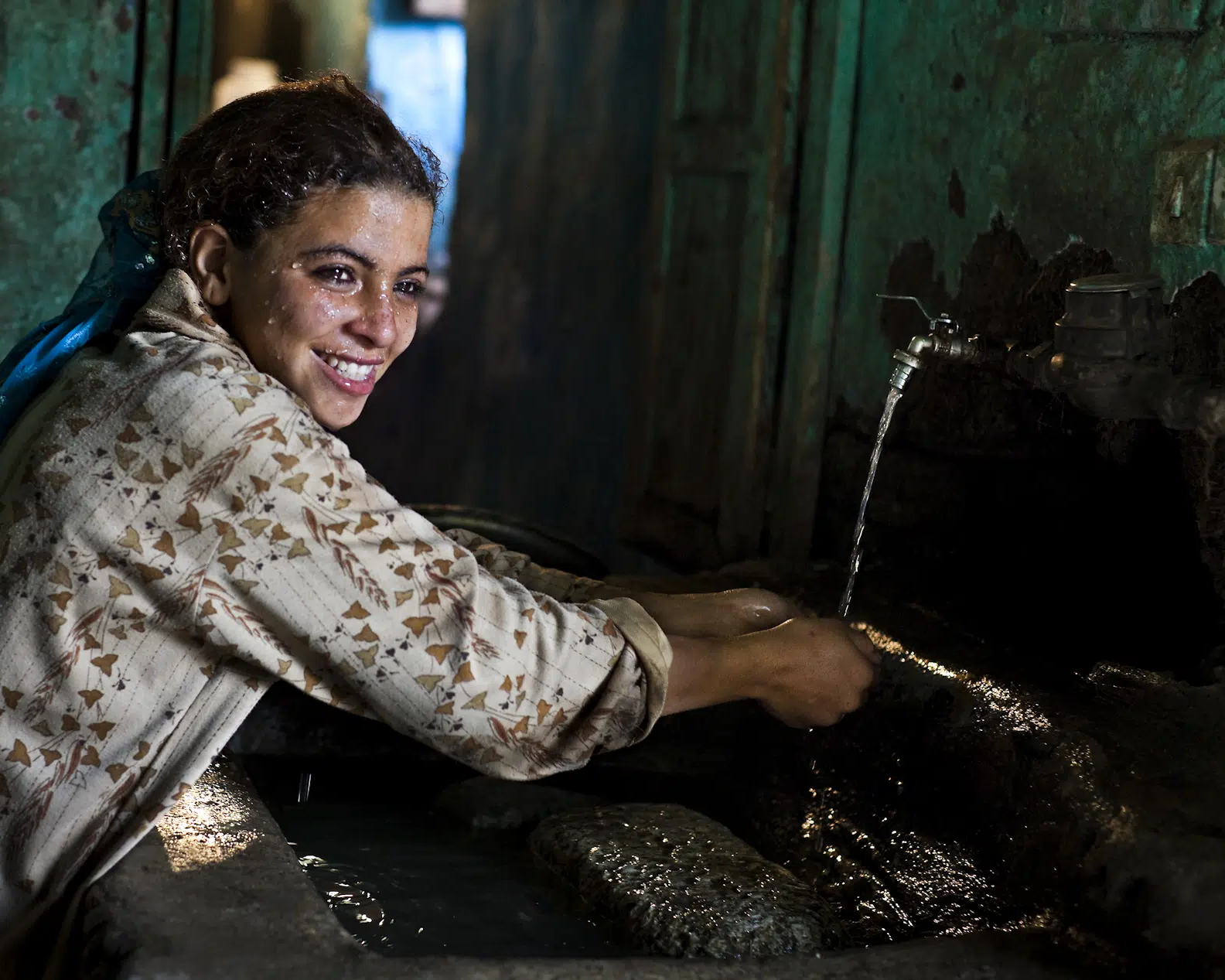 Woman in front of a tap with running tap water