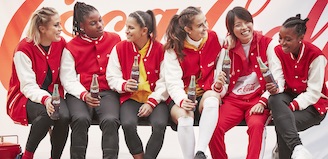 Smiling women in Varsity jackets drinking coke