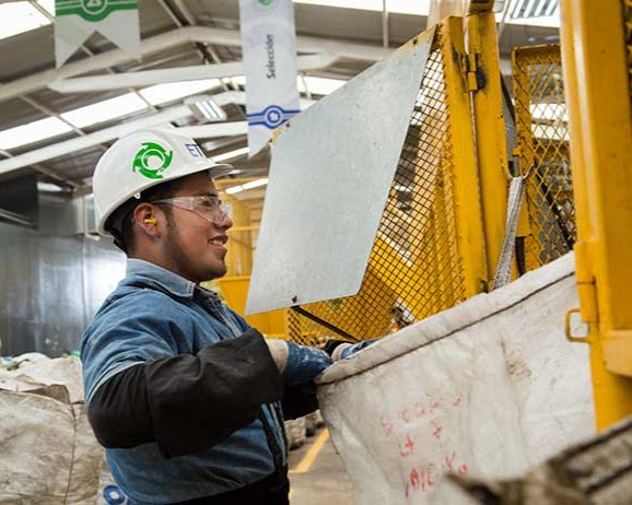 A man is working sorting recylable materials