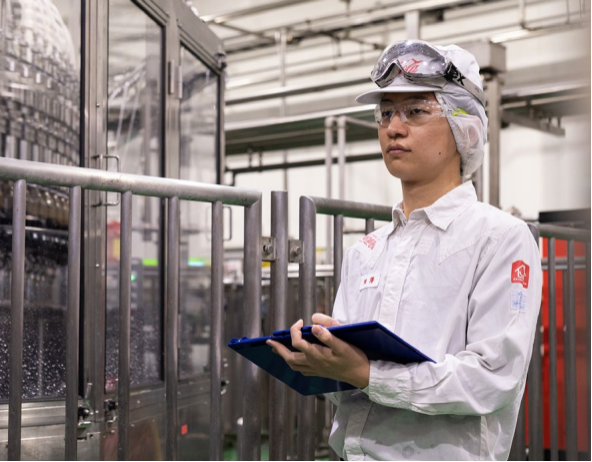 Coca-Cola factory employee with clipboard 