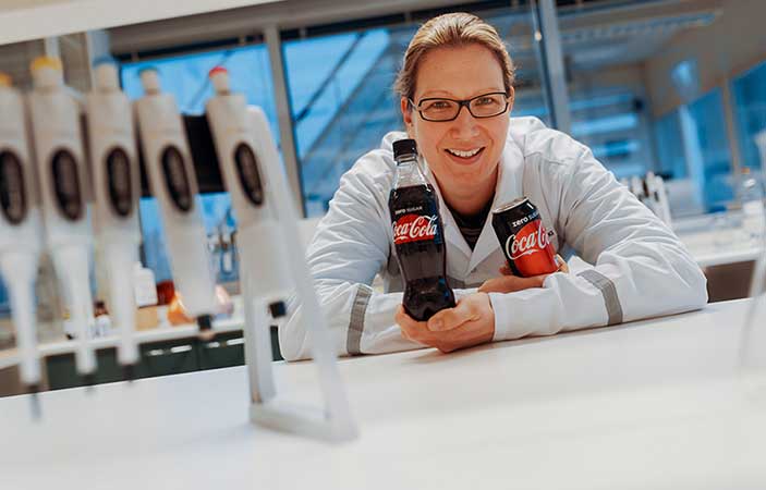 Woman holding Coca-Cola Zero Sugar in product research and development center
