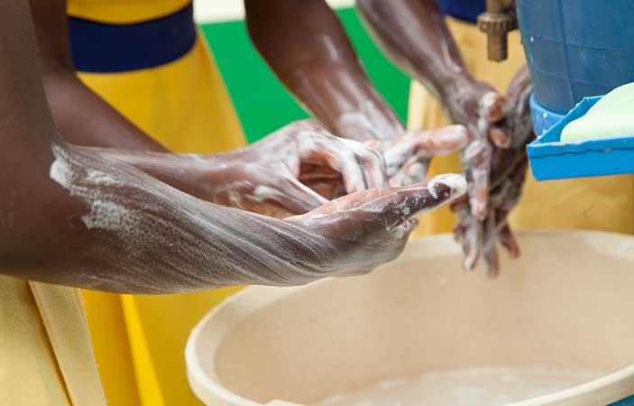 Children washing hands with clean water
