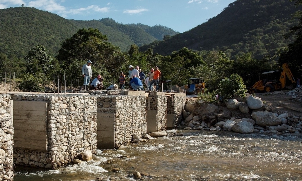 Workers build a DAM on a river in the Sierra de las Minas in Guatemala.