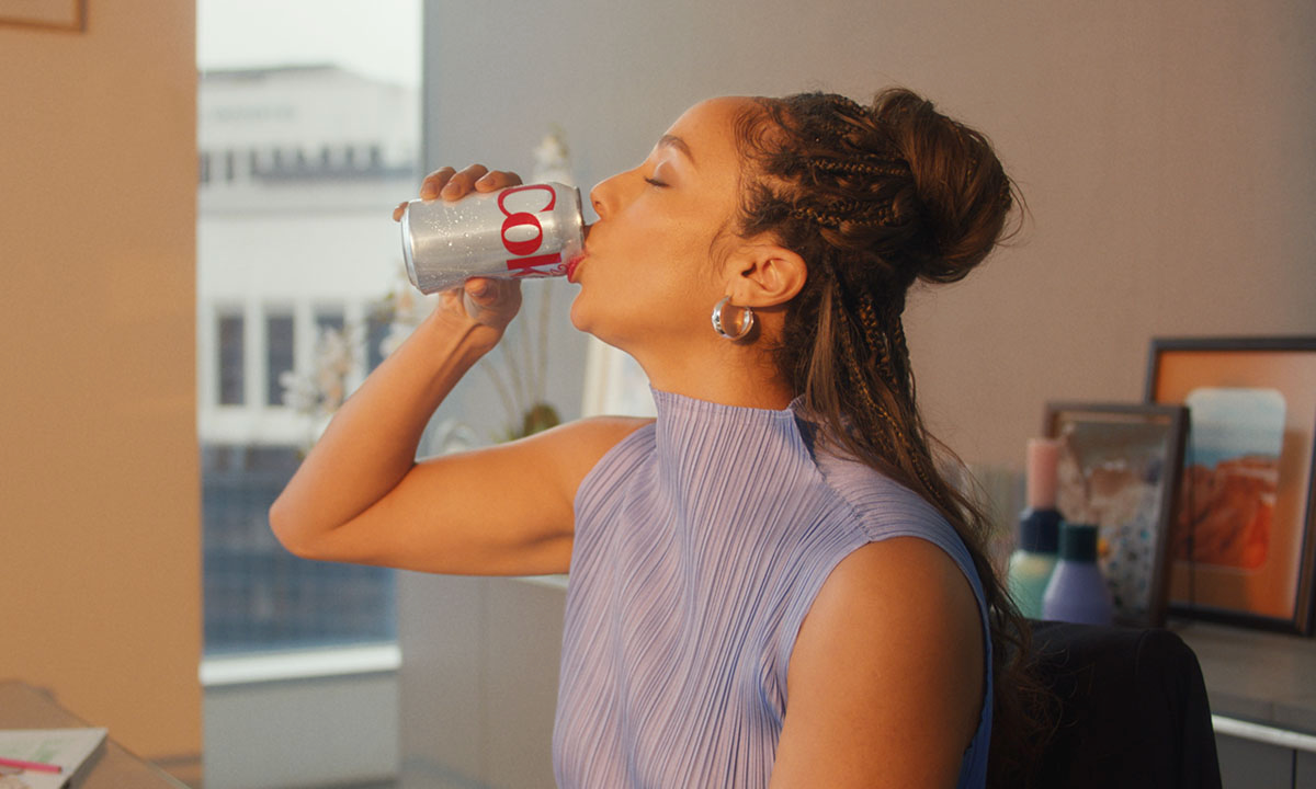 Woman drinking from a Diet Coke can
