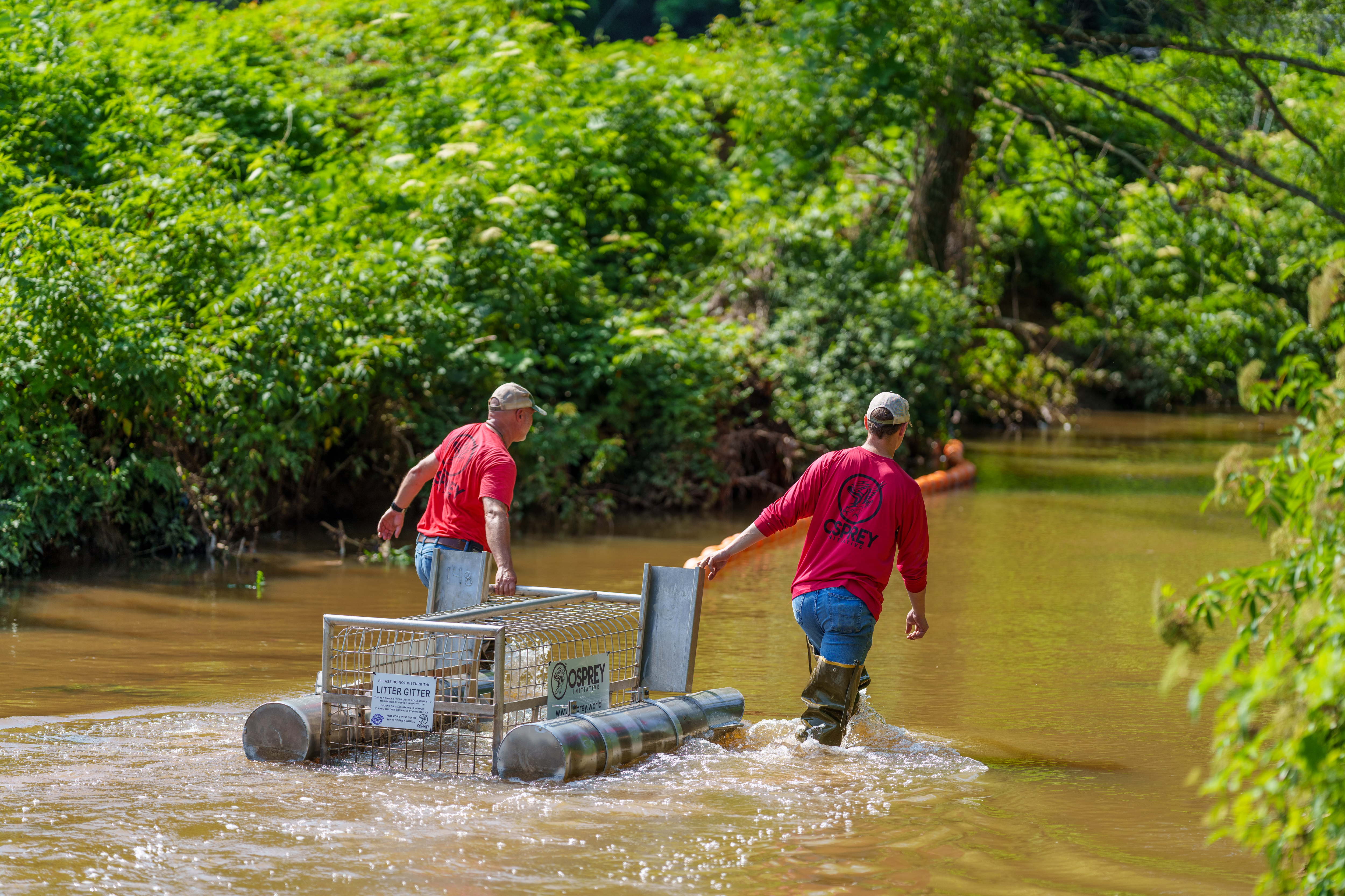 Osprey Initiative volunteers walk a Litter Gitter to its collection point.
