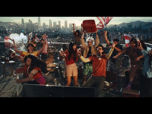 People celebrating on a rooftop while watching a FIFA match.