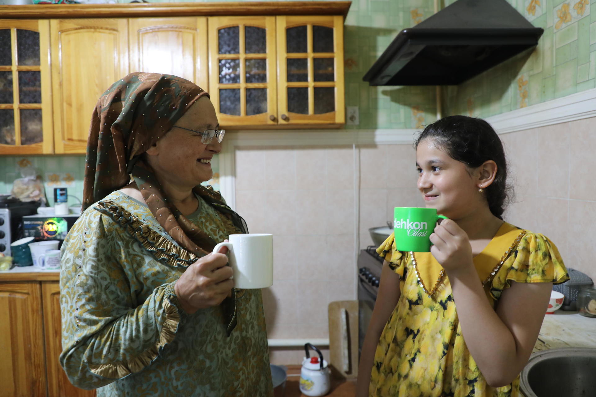 Woman and child holding mugs