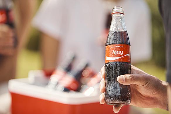 Coca-Cola bottle with Ajay's name.