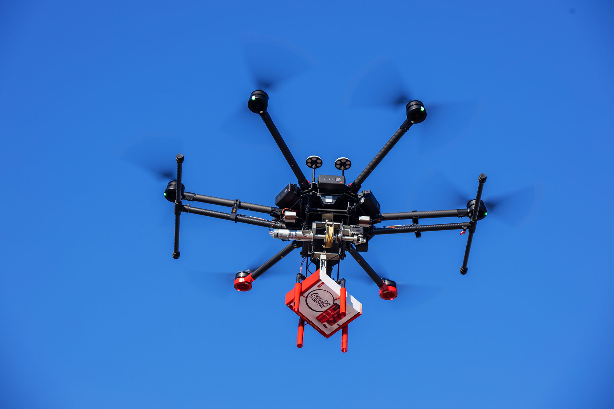 A drone in flight with Coca-Cola with Coffee.